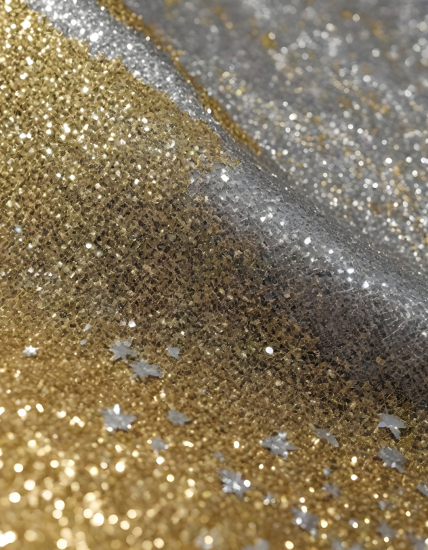 Shimmering gold and silver fabrics layered together in a luxurious arrangement during daylight