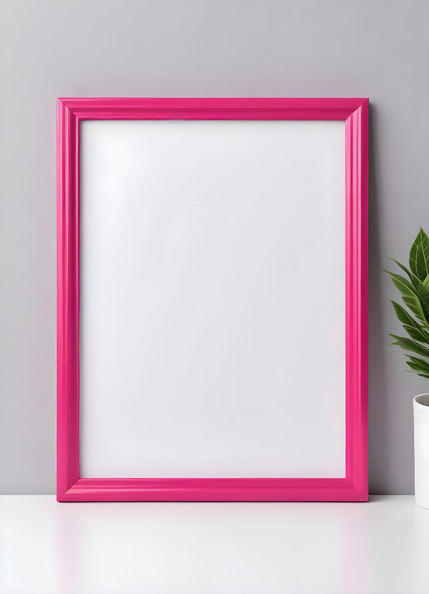 Bright pink empty frame stands against a white wall, inviting creativity and personal expression