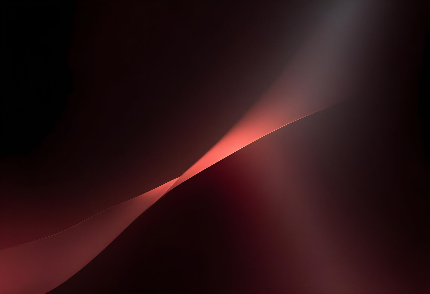 A soft glowing curve against a deep red background creates an abstract and calming visual experience in a minimalist setting