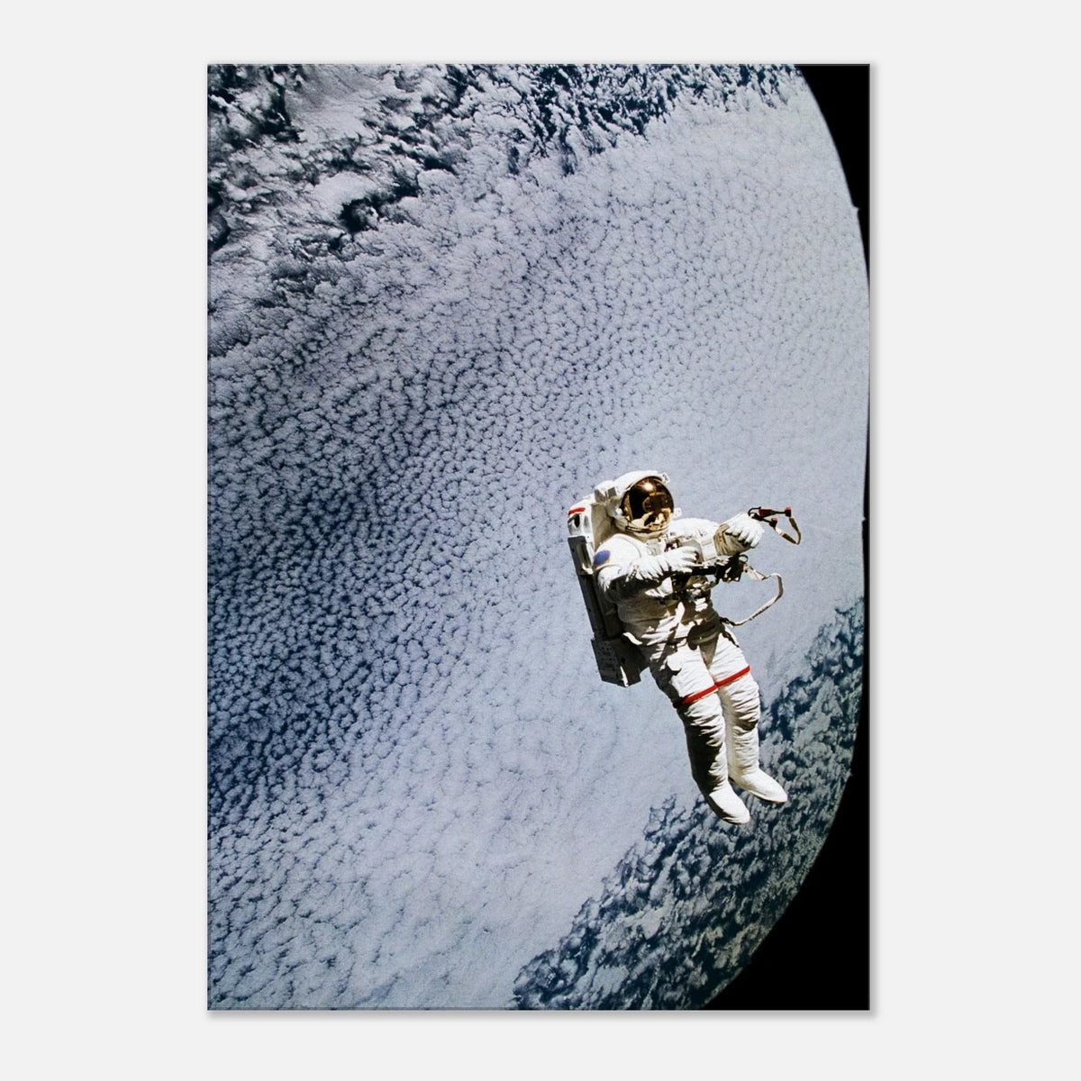Canvas print showing astronaut Mark C. Lee floating above Earth’s clouds while testing the SAFER rescue system displayed against a pale background