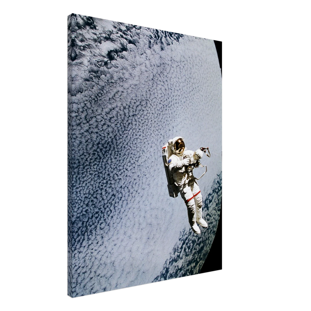 Canvas print showing astronaut Mark C. Lee floating above Earth’s clouds while testing the SAFER rescue system in an angled product view