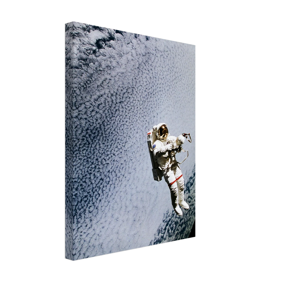 Canvas print showing astronaut Mark C. Lee floating above Earth’s clouds while testing the SAFER rescue system in an angled product view