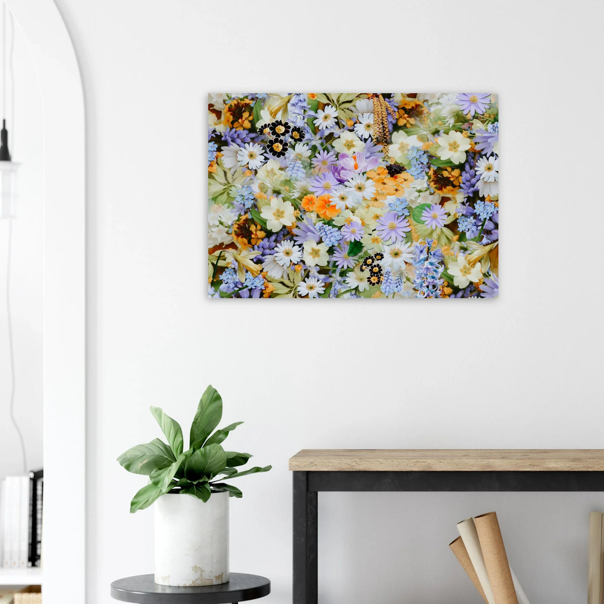 Poster of a dense illustration of pastel flowers with orange accents above a wooden console beside a plant