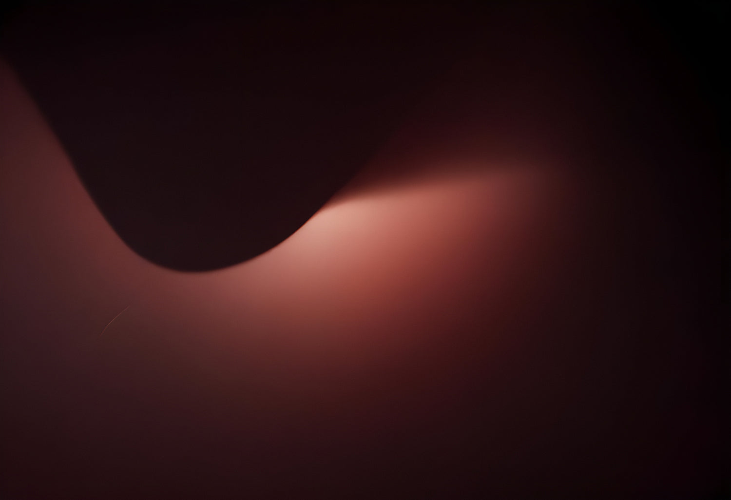 Abstract play of light and shadow creating gentle curves in a softly lit space during the evening hours