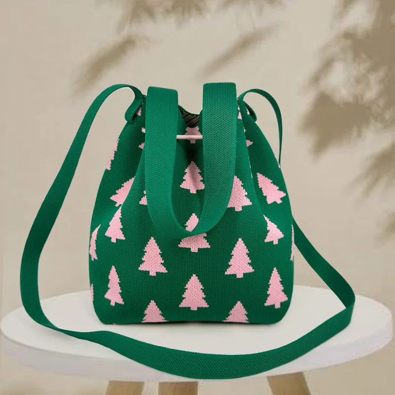 Green bag with pink tree pattern on a white surface