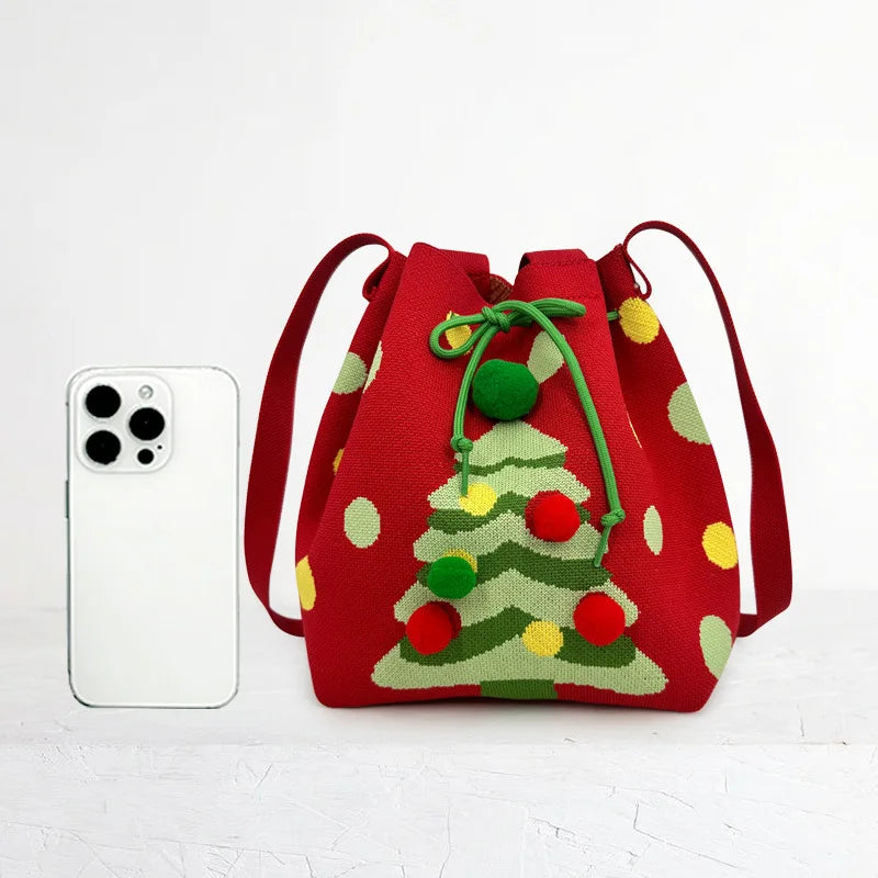 Red drawstring bag with Christmas tree design next to a smartphone on a white background