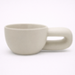 White ceramic mug with handle on a white background
