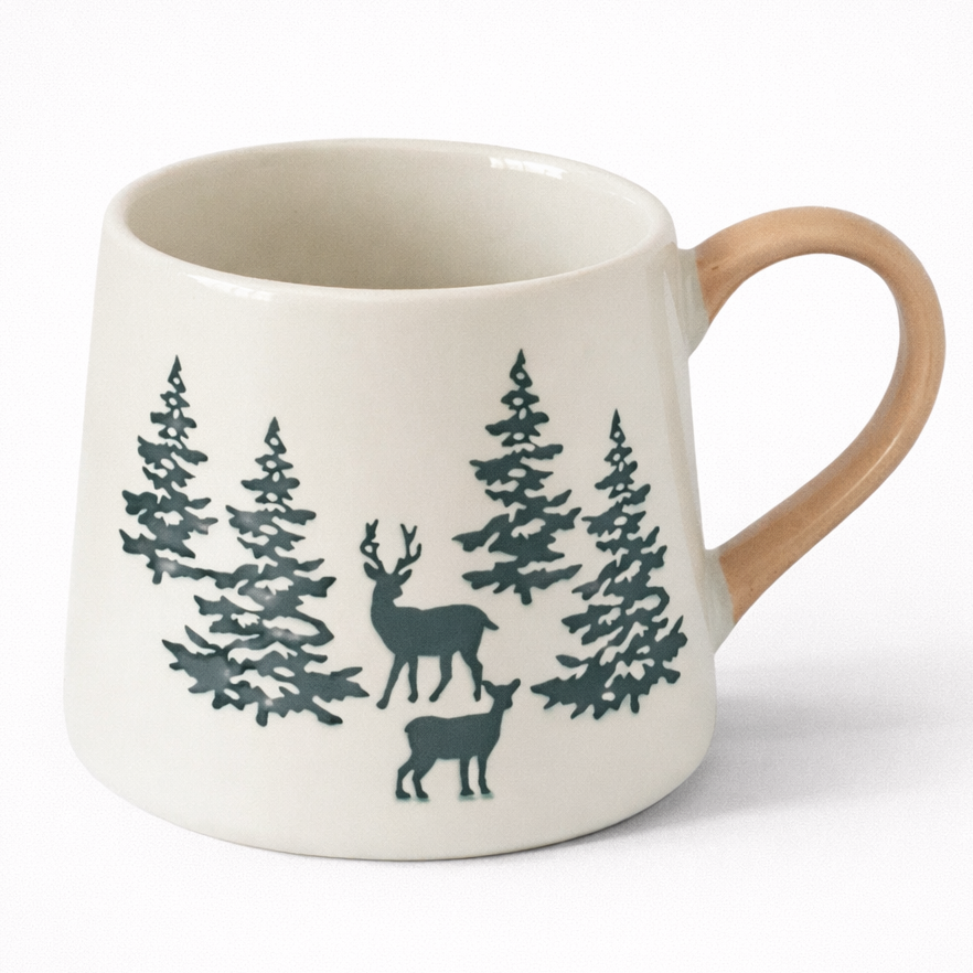 White mug with deer and tree design on a white background