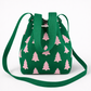 Green bag with pink tree pattern on a white background