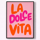 Framed poster with 'La Dolce Vita' text on a pink background