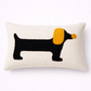 Decorative pillow with a dachshund design on a white background