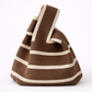 Brown and beige striped bag on a white background