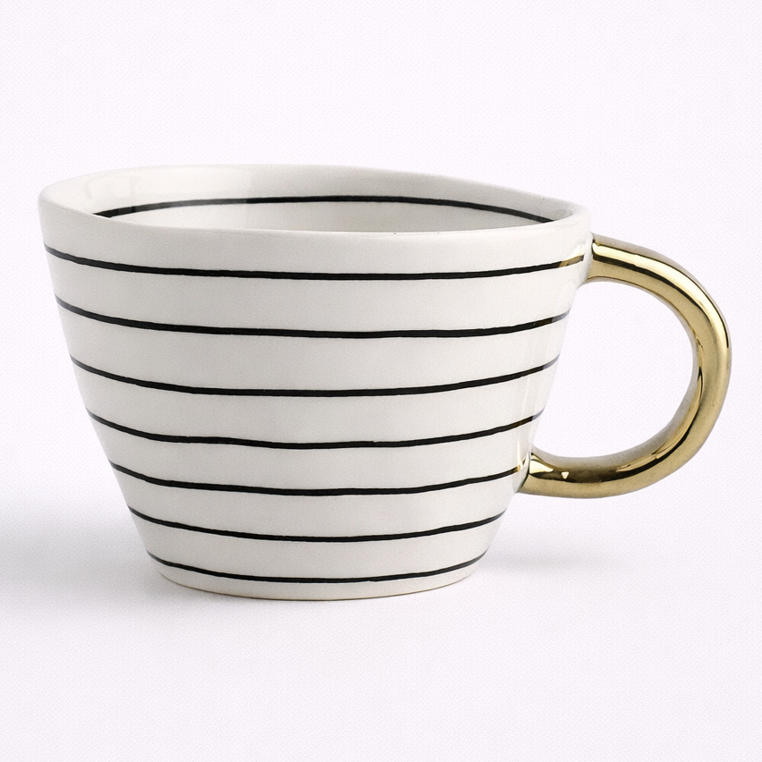 White mug with black stripes and a gold handle on a white background