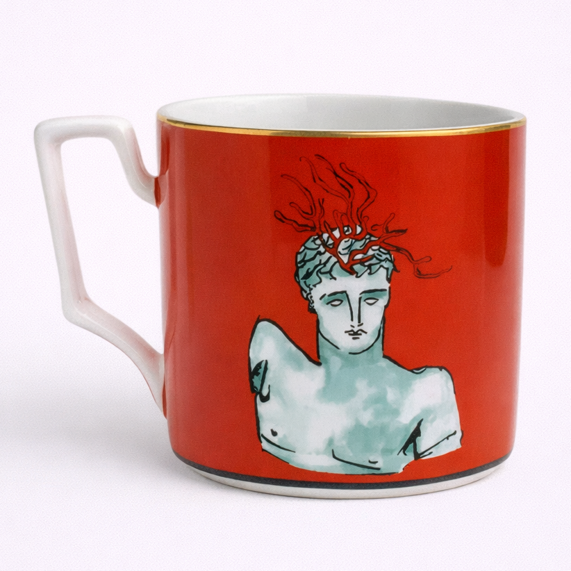 Red mug with classical sculpture design on a white background