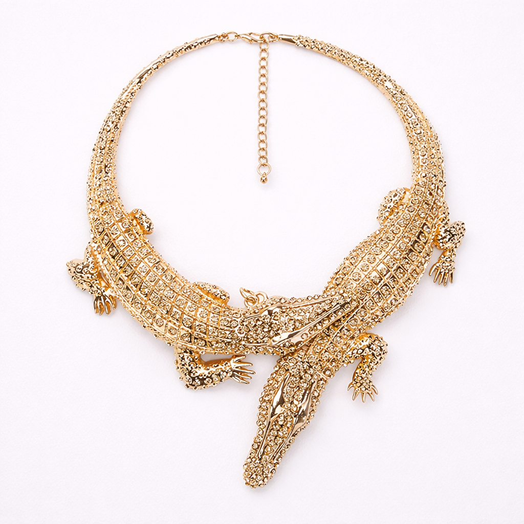 Gold crocodile neckpiece on a white background