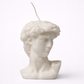 Candle shaped like a classical bust on a white background
