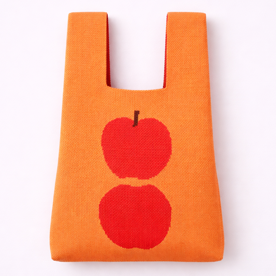 Orange reusable bag with red apple design on a white background