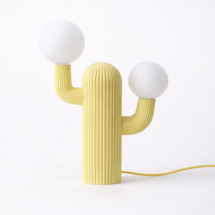 Yellow cactus-shaped lamp with two white spherical lights on a white background