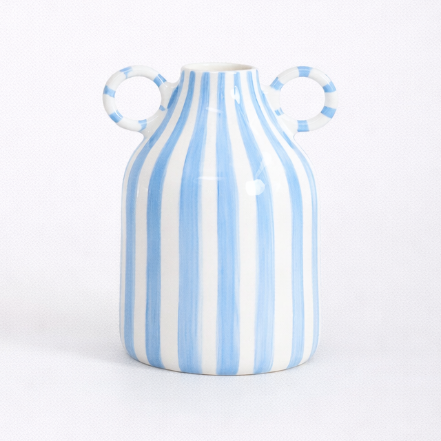 Blue and white striped ceramic vase on a white background