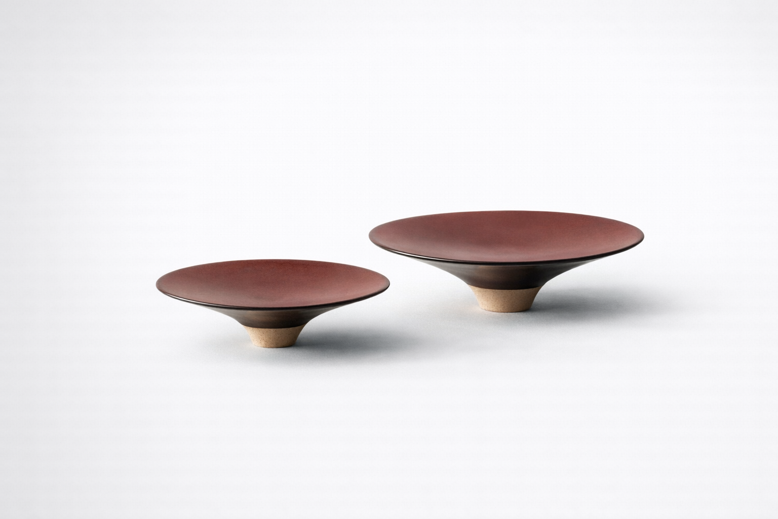 Two ceramic bowls with a brown and beige color scheme on a white background