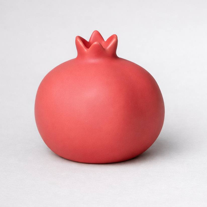 red ceramic pomegranate ornament styled product view