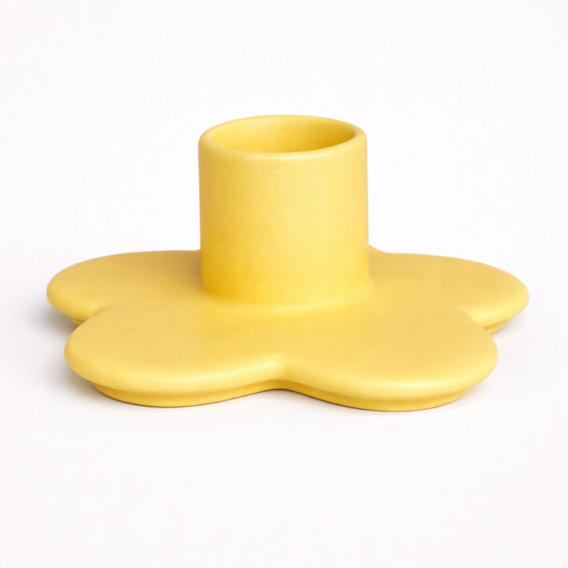 Yellow flower-shaped cup holder on a white background