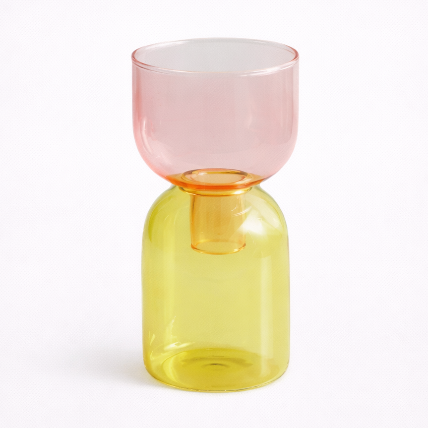 Two-toned glass vase with pink top and yellow bottom on a white background