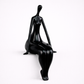 Black mannequin on a white shelf against a white background