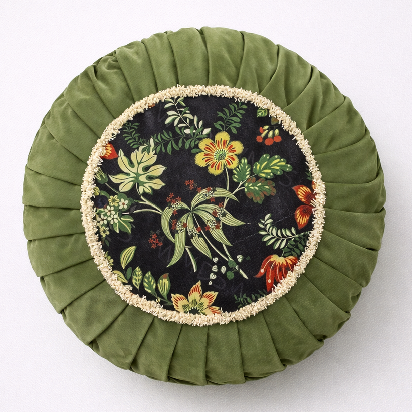 Round green cushion with floral pattern on a white background