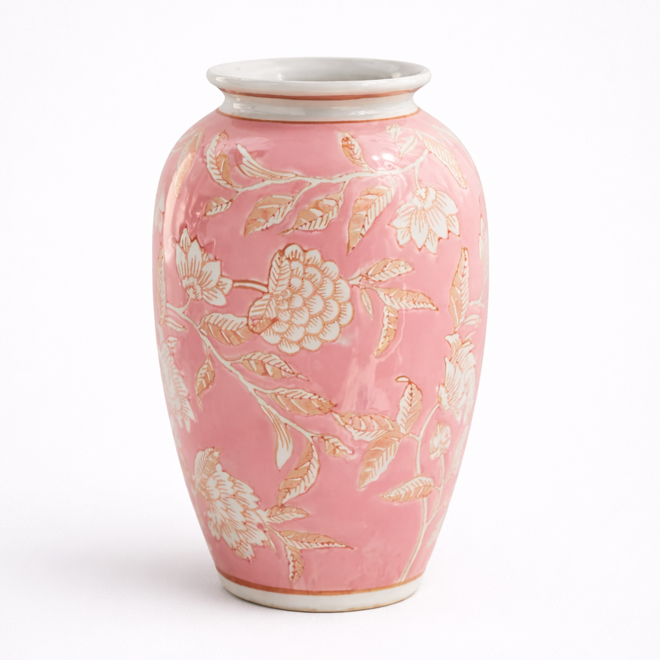 Pink ceramic vase with floral patterns on a white background