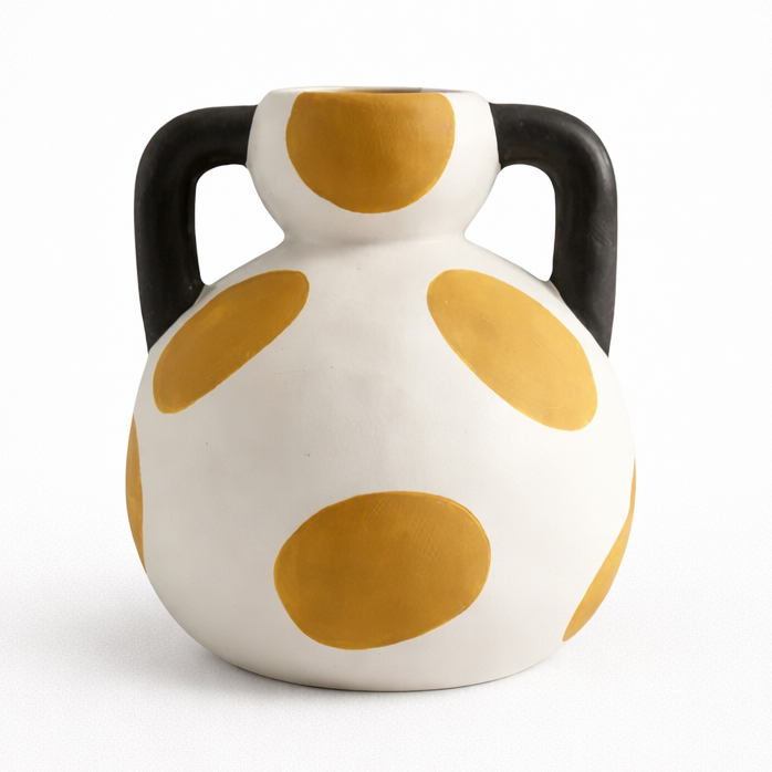 Ceramic vase with yellow polka dots and black handles on a white background