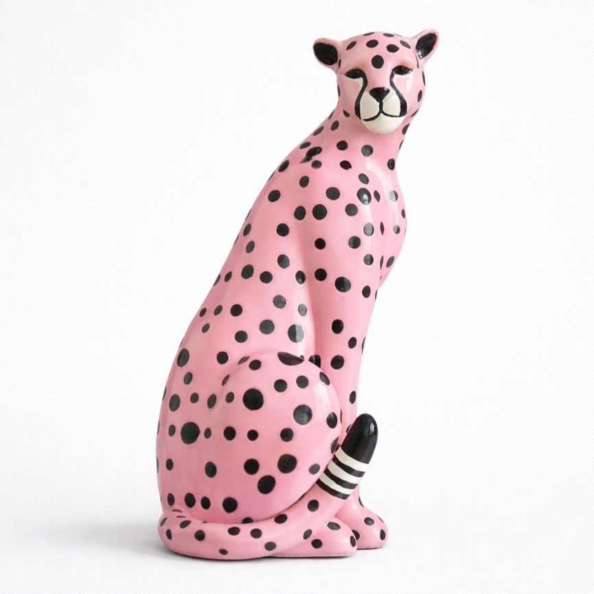 Pink cheetah figurine with black spots on a white background