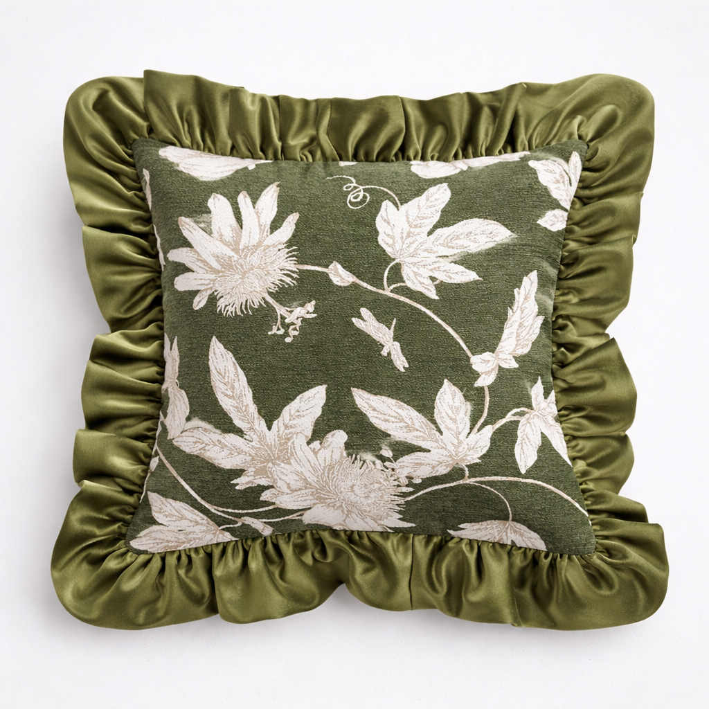 Decorative pillow with floral pattern and green ruffled edges on a white background