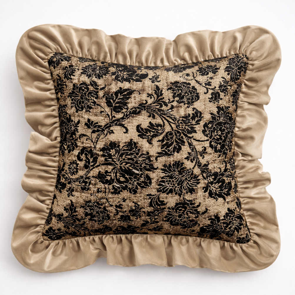 Decorative pillow with black floral pattern and beige ruffled edges on a white background