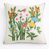 Decorative pillow with embroidered floral design on a white background