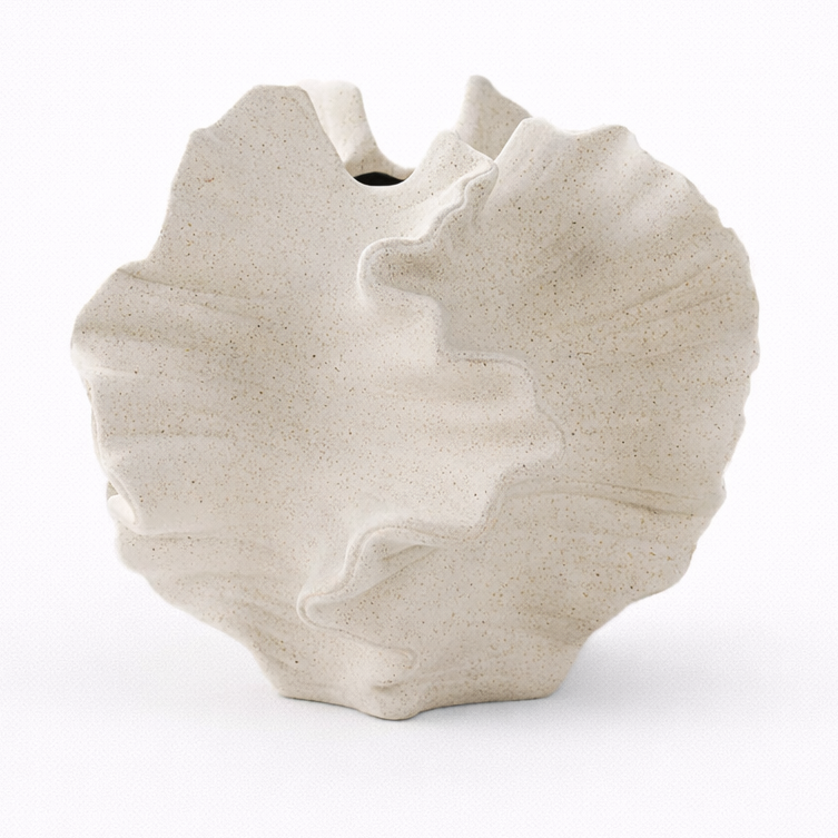 White ceramic vase with a textured, organic design on a white background