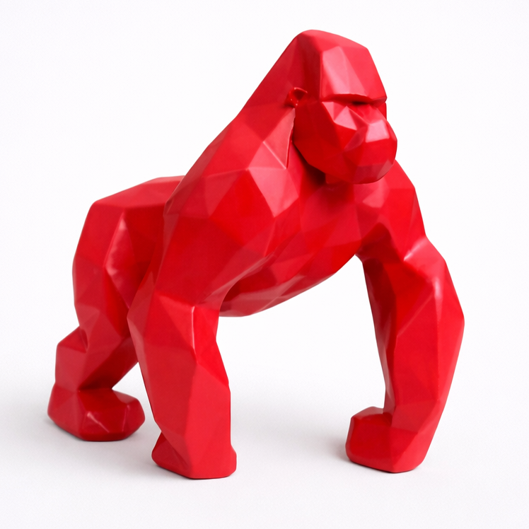 Red gorilla figurine on a white background