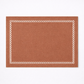 Rectangular brown rug with a white geometric border on a white background