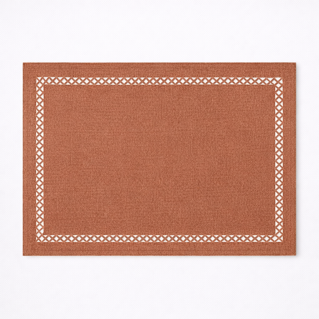 Rectangular brown rug with a white geometric border on a white background