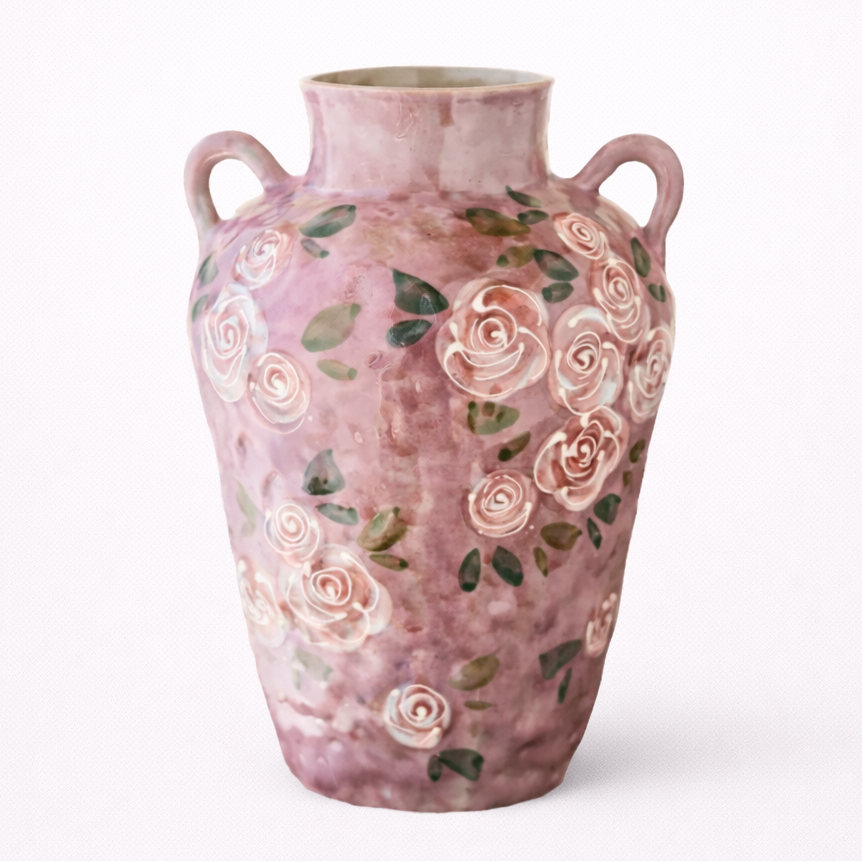 Pink ceramic vase with floral designs on a white background