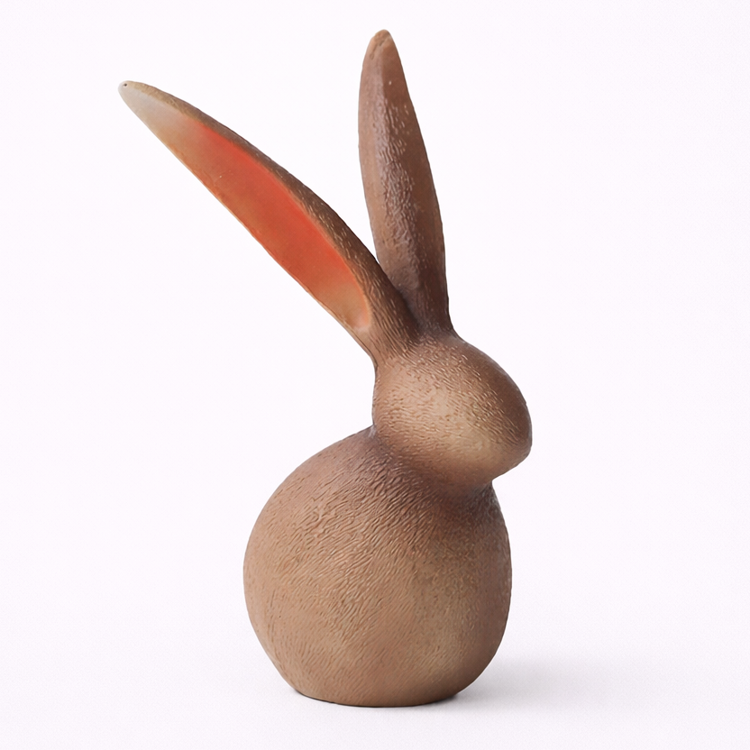 Wooden rabbit figurine on a white background