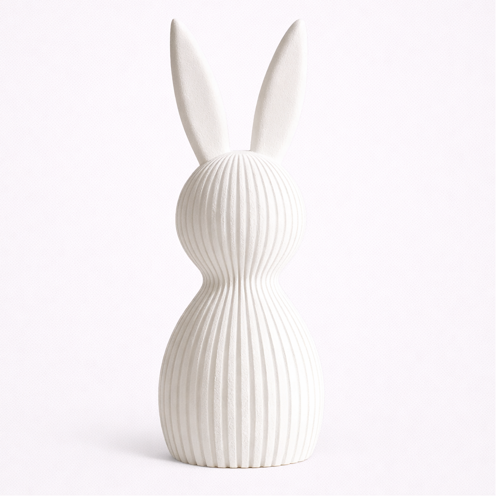 White rabbit-shaped vase with ribbed texture on a white background
