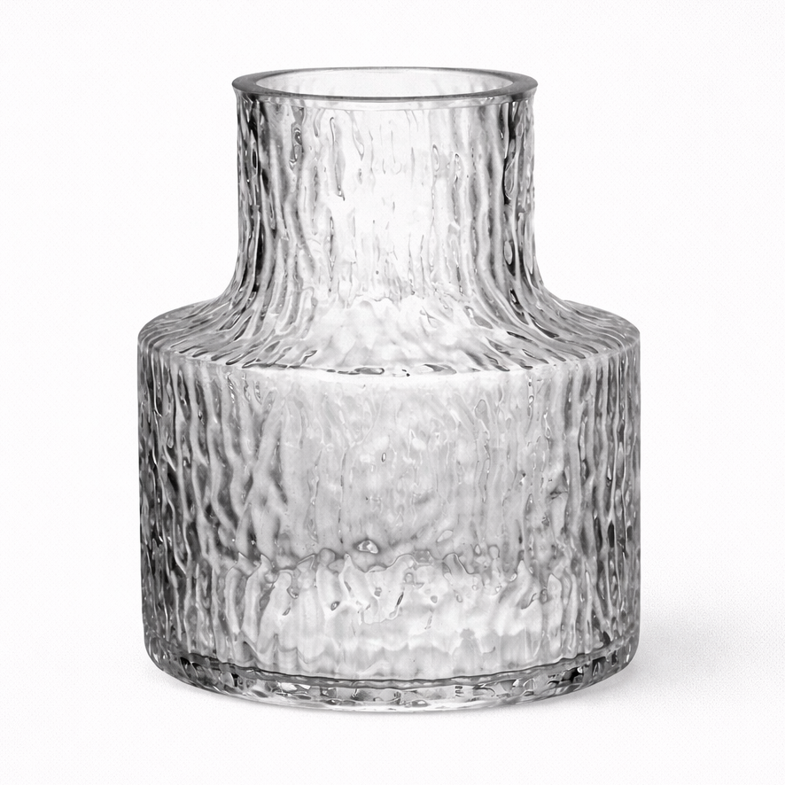 Clear glass vase with textured surface on a white background