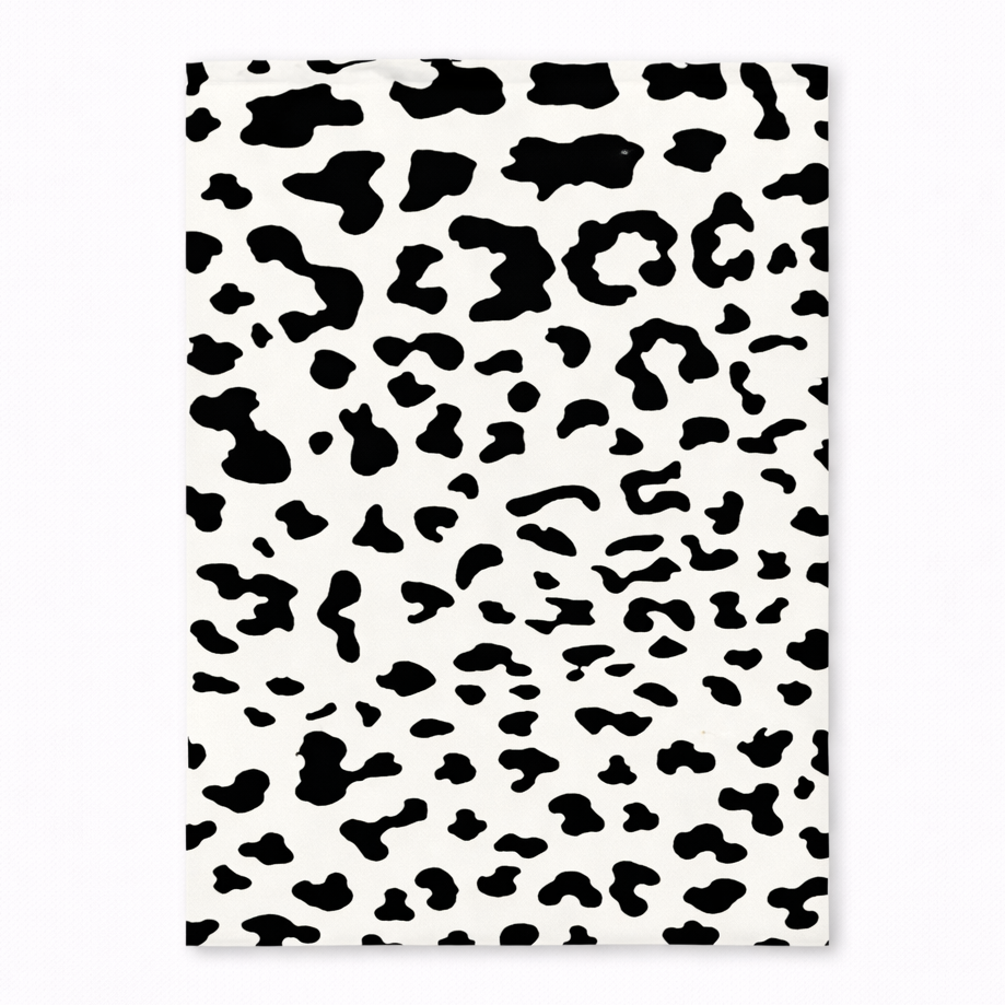 Notebook with black and white leopard print pattern on a white background