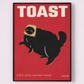 Poster with a black cat wearing a toaster costume on a red background with 'TOAST' text.