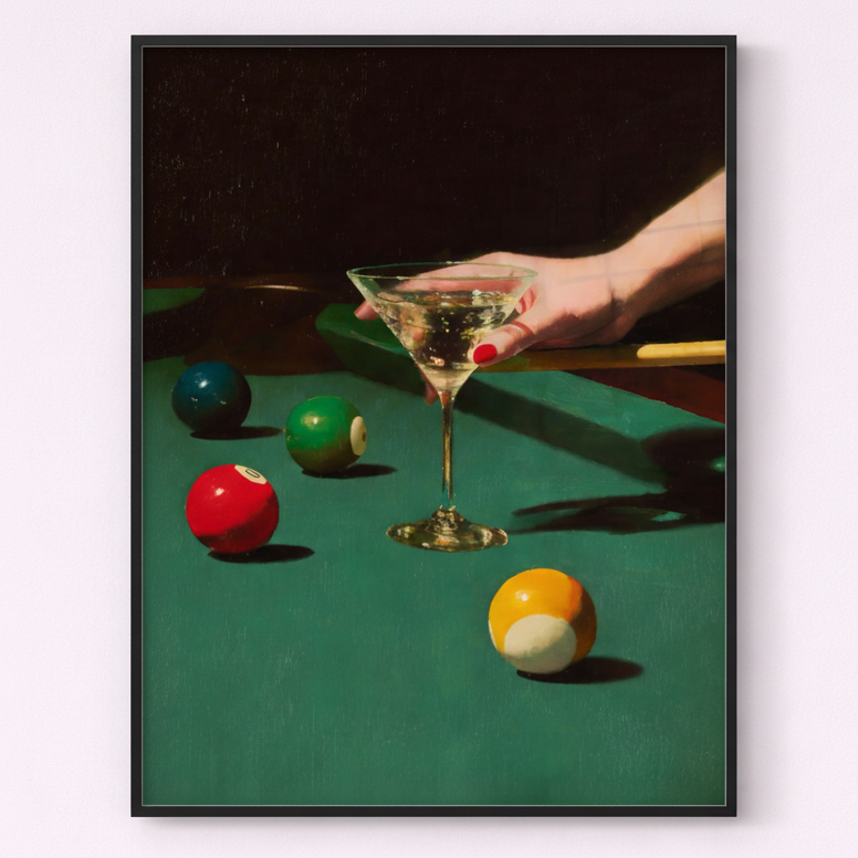 Framed artwork of a hand holding a cocktail glass on a pool table with colorful balls.