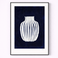 Framed artwork of a white vase on a dark blue background