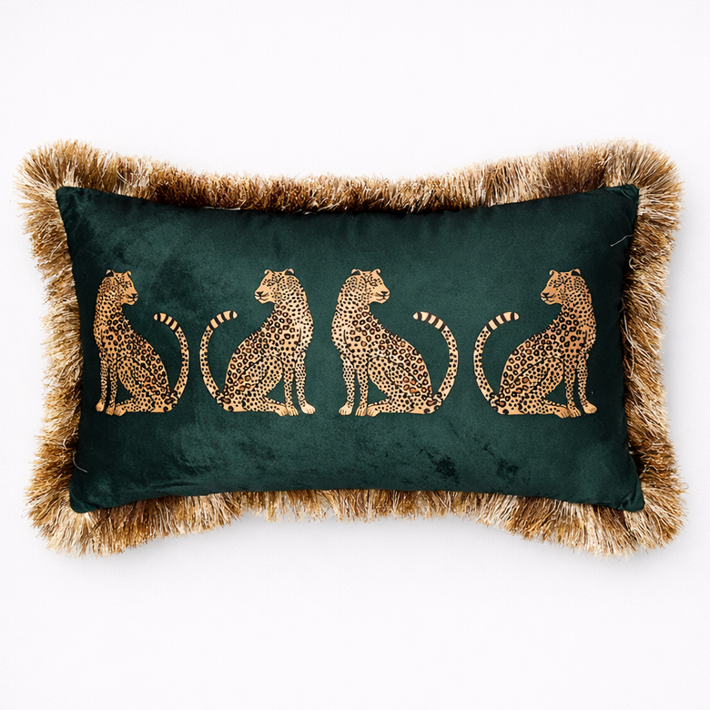 Decorative pillow with embroidered leopards on a green background