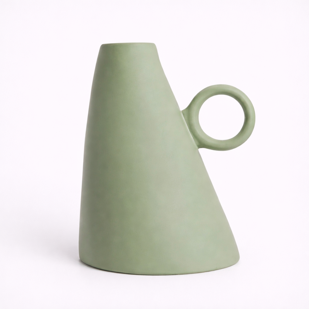 Green ceramic vase with a circular handle on a white background