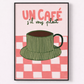 Framed artwork with a green coffee cup on a pink checkered background and text 'UN CAFé s'il vous plaç'.